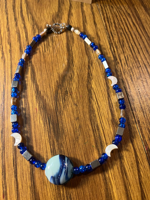 Blue Moon Beach full necklace showing cobalt blue beads, moon charms, and swirled art glass focal bead