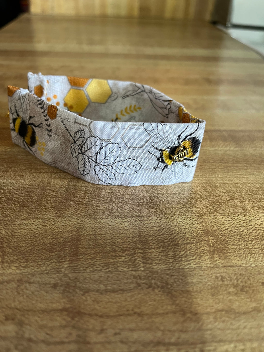 Bee Still fabric wrist cuff worn view