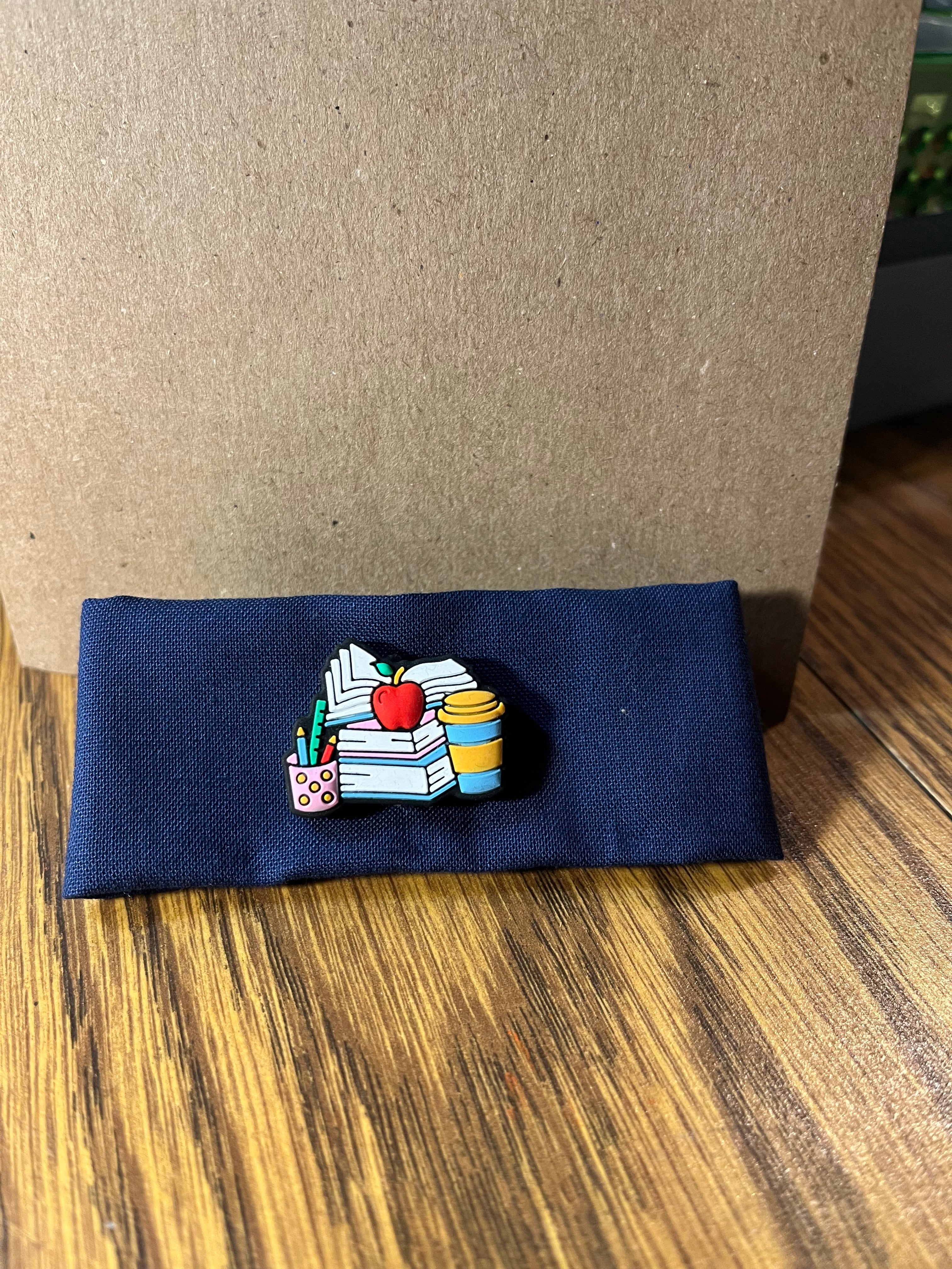 Hittin' the Books navy wrist wrap folded showing books charm