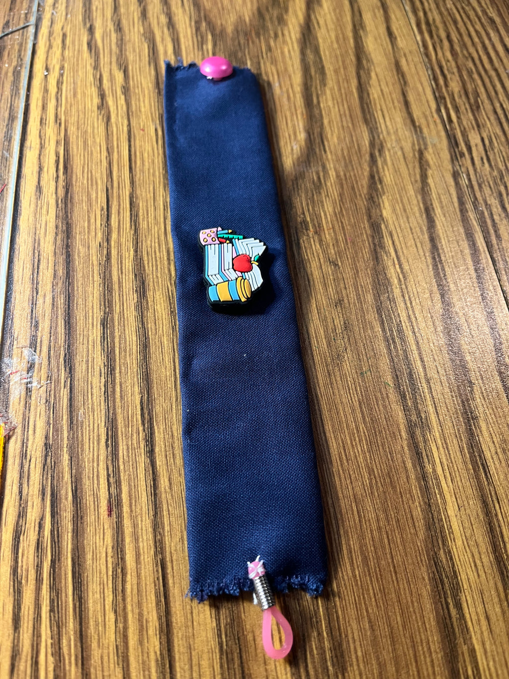 Hittin' the Books navy wrist wrap full length showing pink snap closure