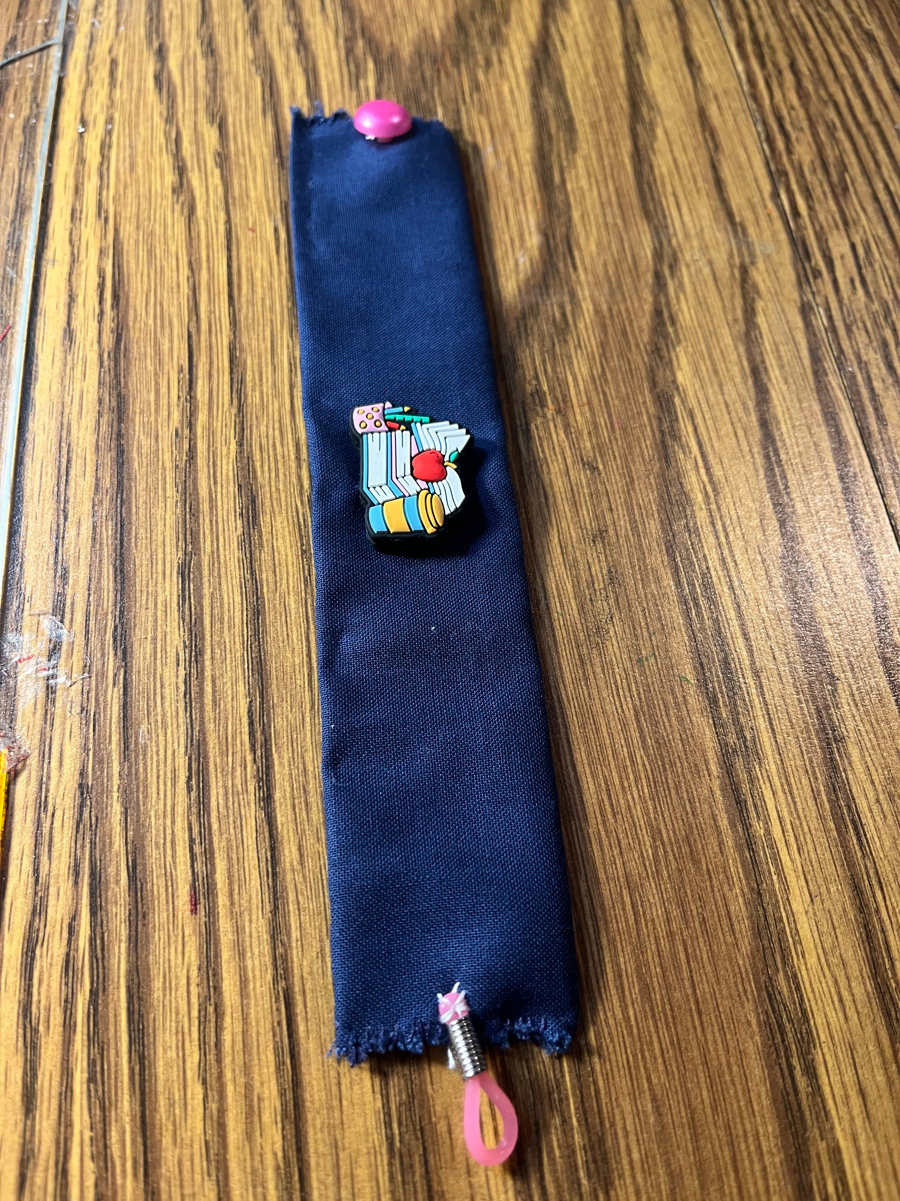 Hittin' the Books navy wrist wrap full length showing pink snap closure