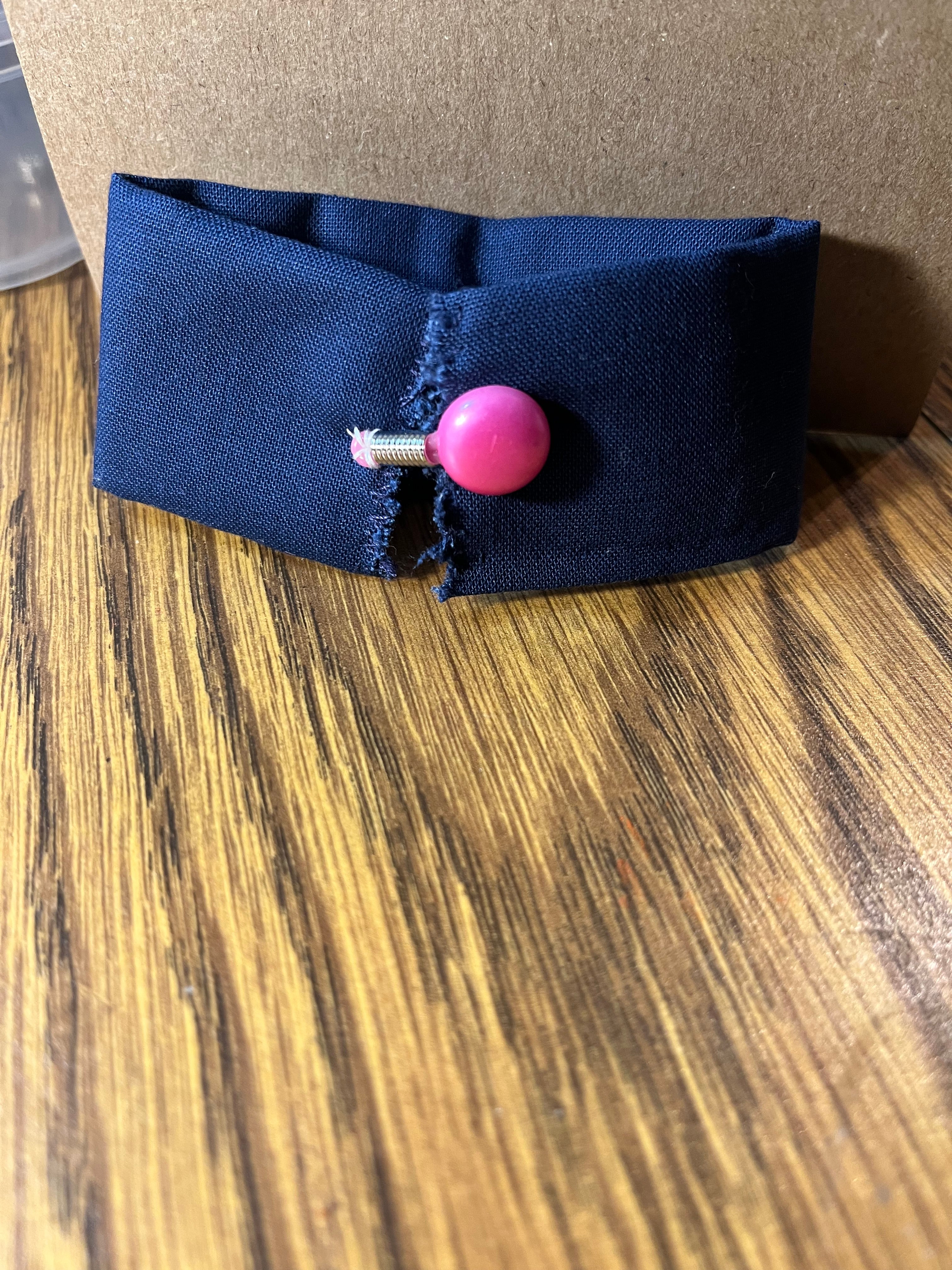 Hittin' the Books navy wrist wrap close-up showing pink snap button closure
