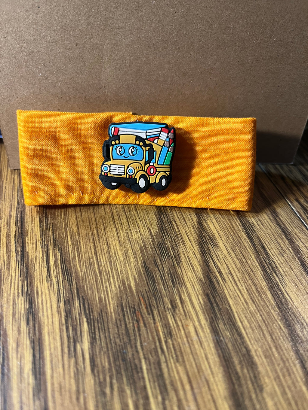 Wheels on the Bus golden yellow wrist wrap folded showing school bus charm