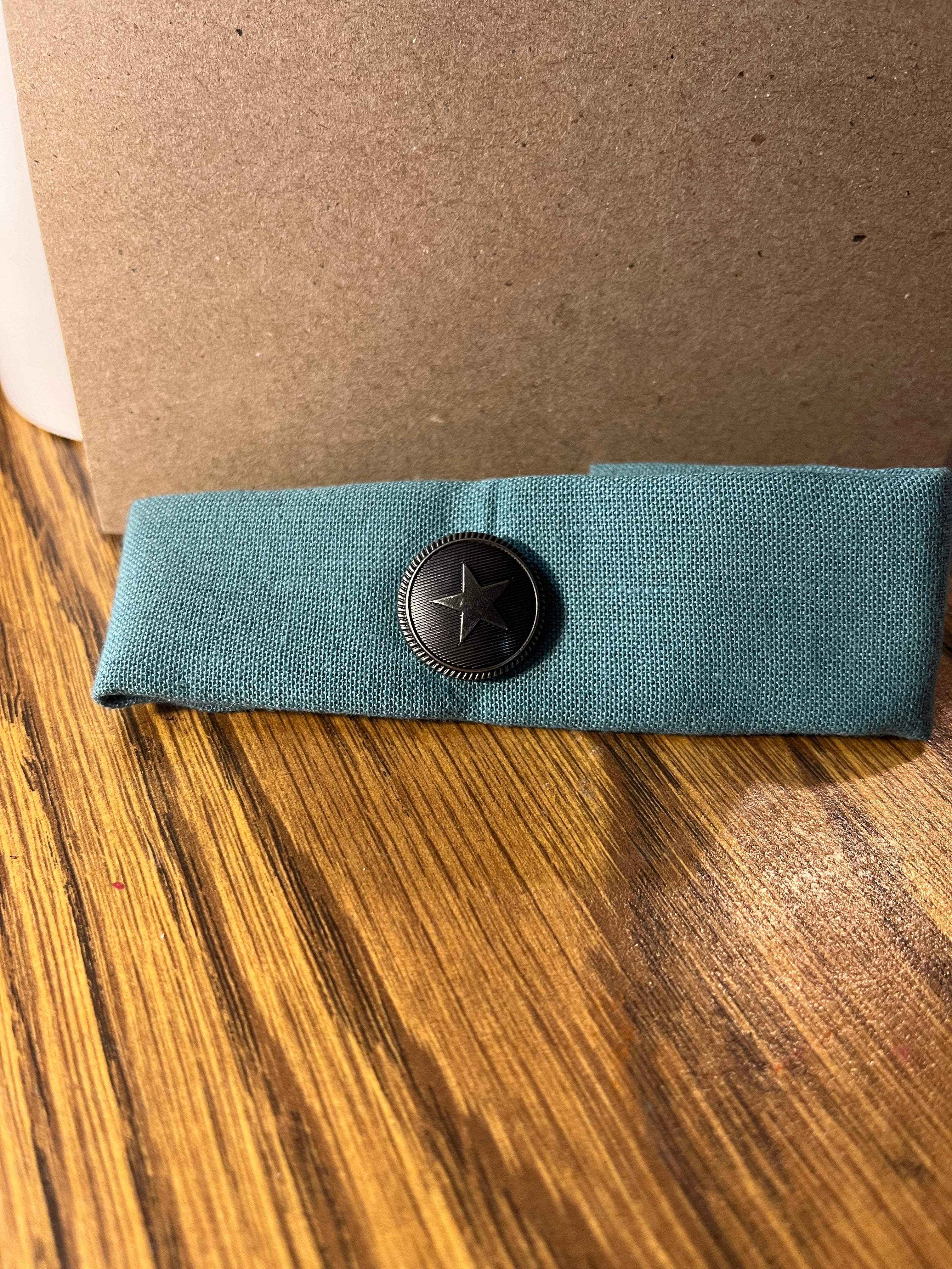 Nautical teal wrist wrap folded showing star concho button