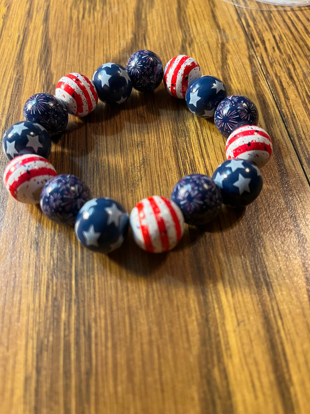 Stars & Stripes Too patriotic beaded stretch bracelet on wood surface