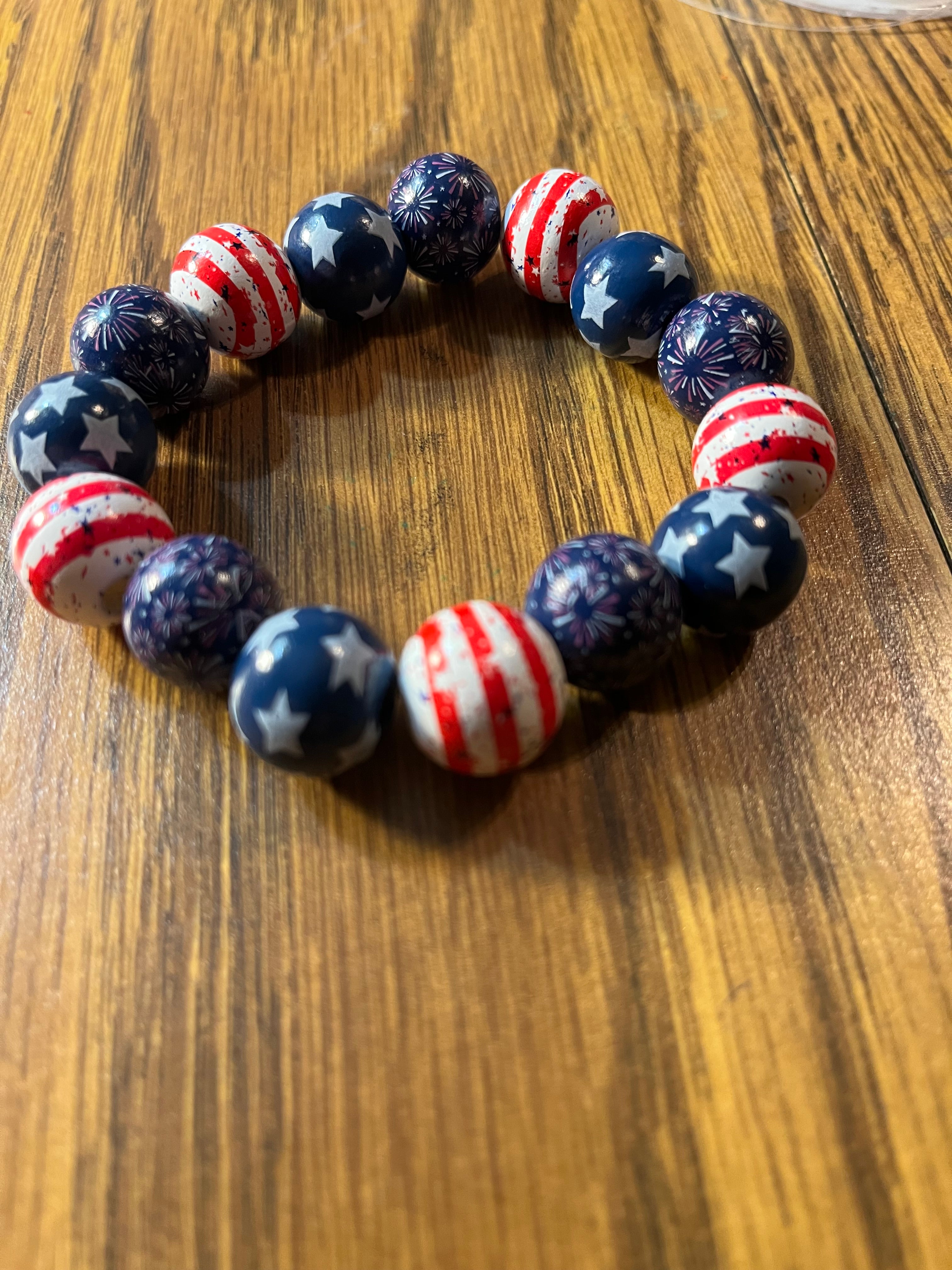 Stars & Stripes Too patriotic beaded stretch bracelet on wood surface