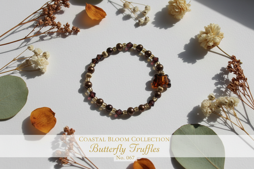Butterfly Truffles beaded bracelet with chocolate brown, amber and gold beads on white surface with botanical accents