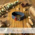 Denim wrist wrap with ABC chalkboard and crayon charms on weathered wood surface
