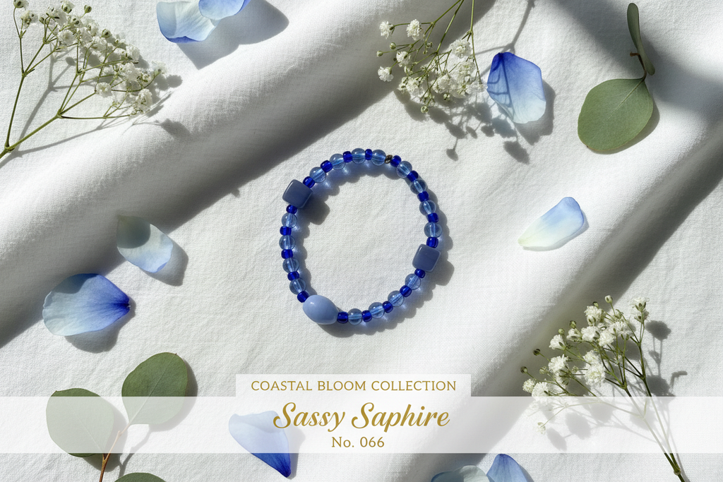 Sassy Sapphire beaded bracelet with cobalt and periwinkle blue beads on a white surface with botanical accents