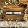 Navy denim and white lace wrist wrap with gold clock charm on weathered wood surface